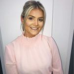 Headshot of Lily Mears, young girl with blonde hair, smiling at the camera