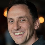 A close-up of a man smiling