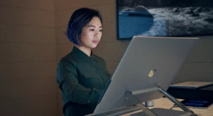 Person working at a desktop computer in a modern office setting.