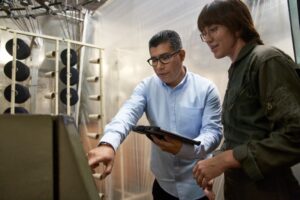 CEO and COO of a textile manufacturing plant working together to manage inventory on the warehouse floor