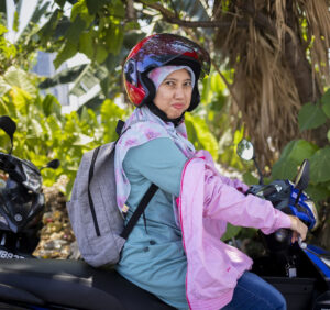Woman in a headscarf on a scooter