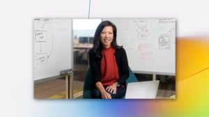 Smiling woman leading a meeting with an Azure branded backdrop