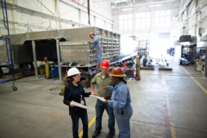 CEO of large manufacturing company; discussing a project with operations manager and foreman.