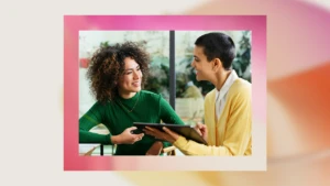 A woman holding a tablet and smiling