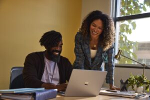 Two education leaders collaborating in an office at an educational institution.