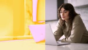 A woman looking at a laptop.