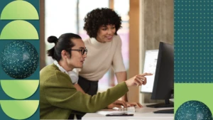 Two education professionals collaborating in a school office.