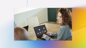 A woman smiling at a laptop