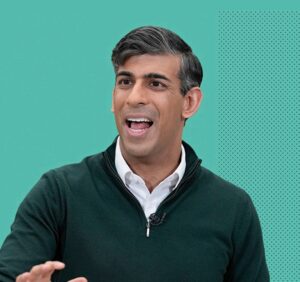 Mann speaking against a green background.