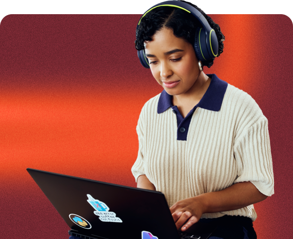 A woman dressed in a white shirt with headphones on, appearing attentive and immersed in audio.