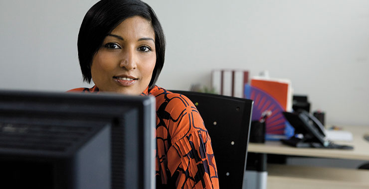 a person standing in front of a computer screen