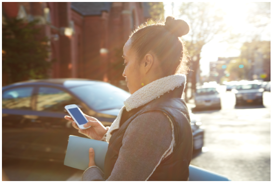 a group of people sitting at a table using a laptop