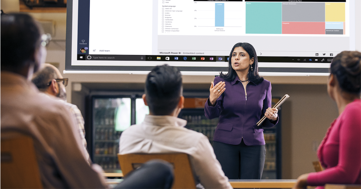 A business person giving an interactive presentation to a group of attendees.