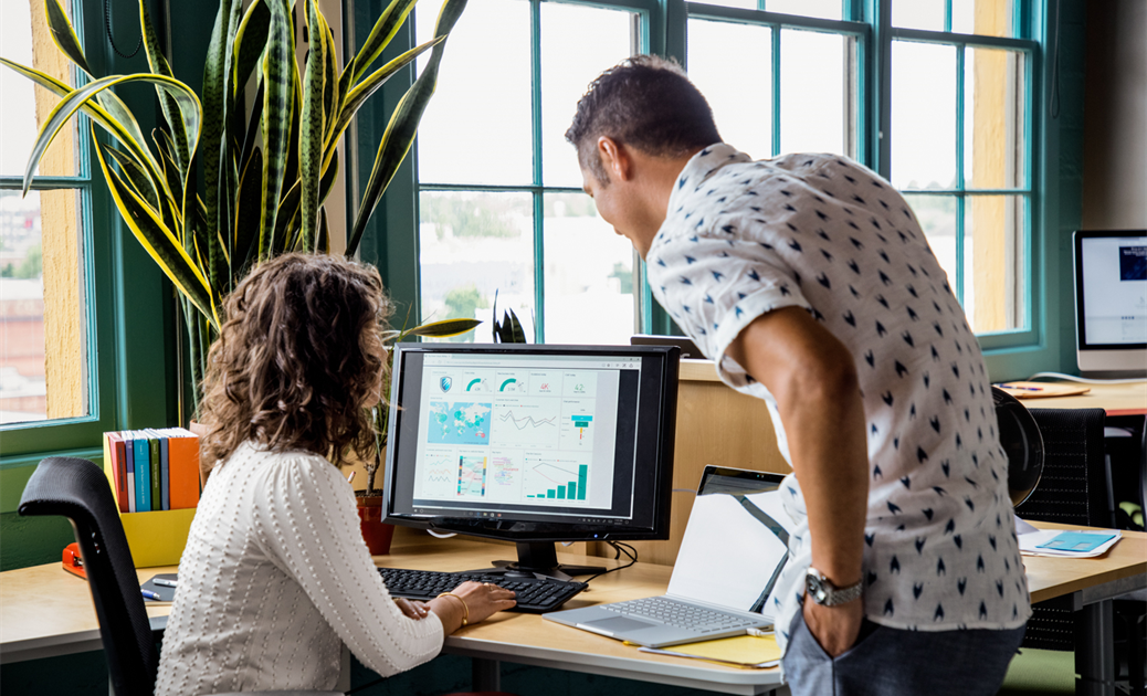 a man standing in front of a computer
