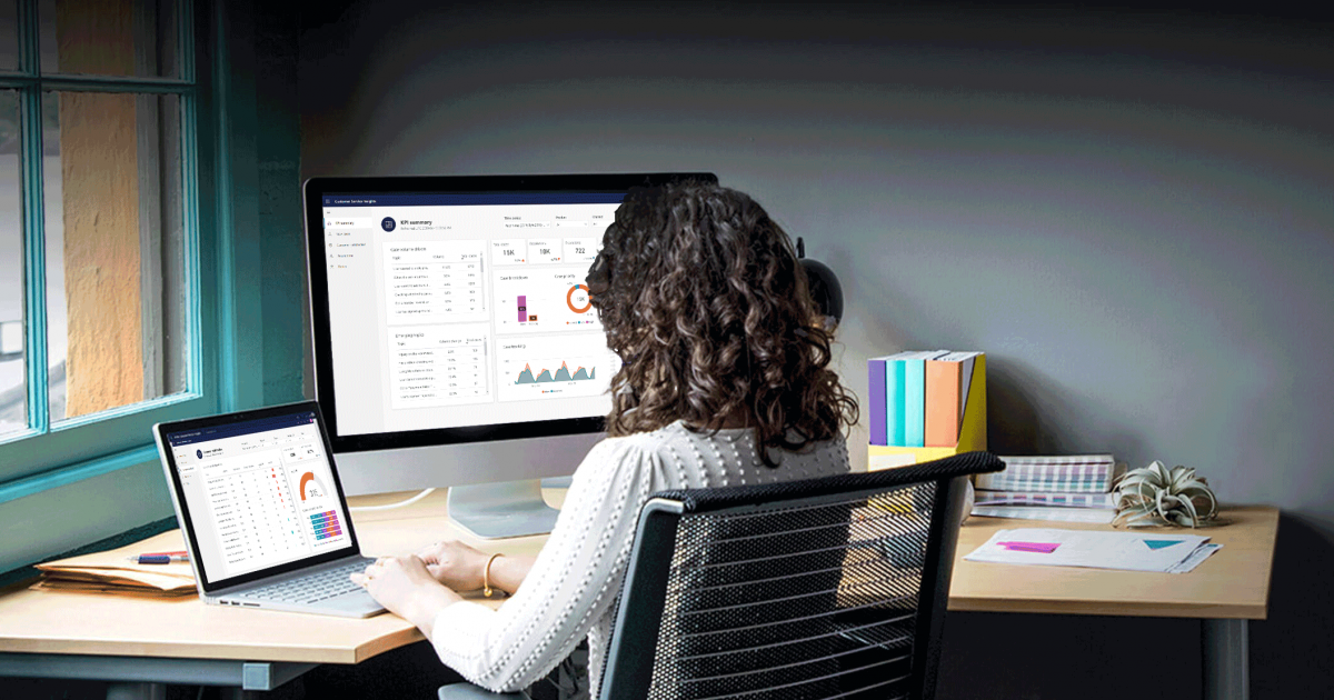 a person sitting at a desk in front of a computer