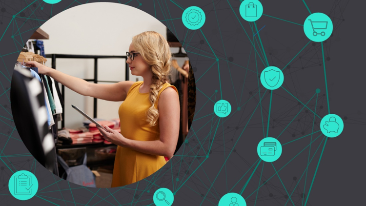 A woman organizing clothing in a retail storefront.