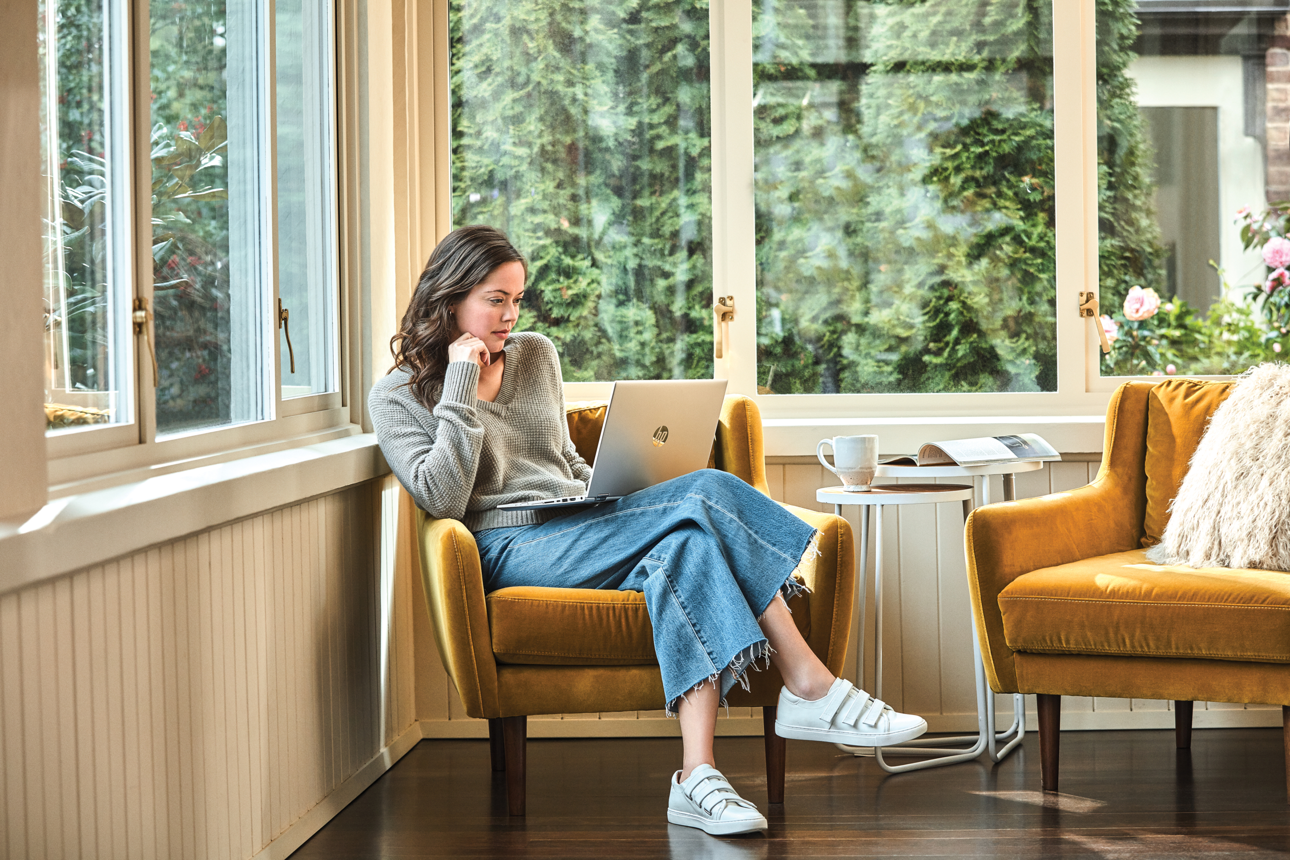 Woman interacting with a HP Pavilion laptop.