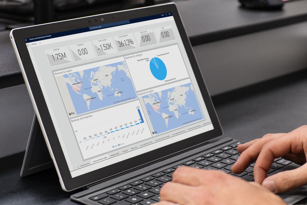 a person using a laptop computer sitting on top of a desk
