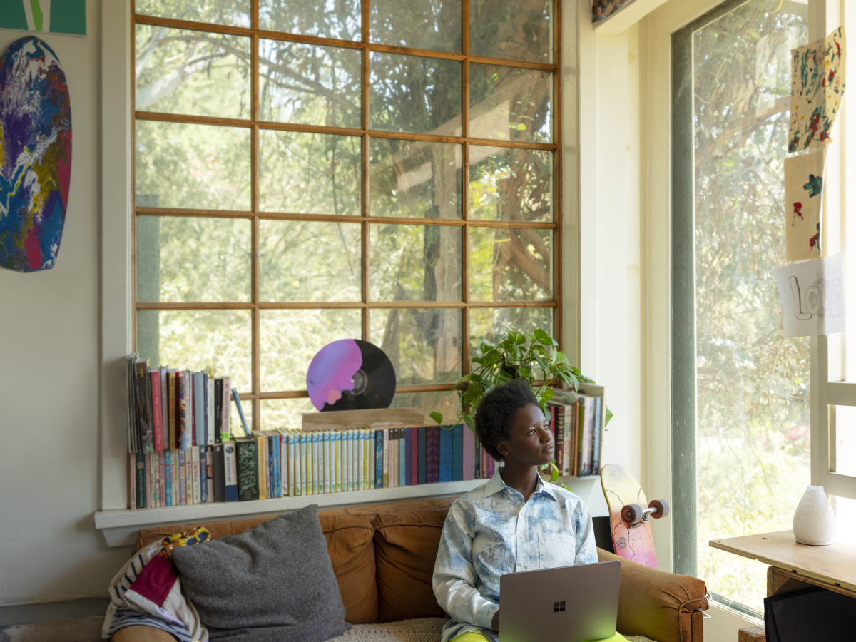 Adult female inside using Surface Laptop Go to work from home