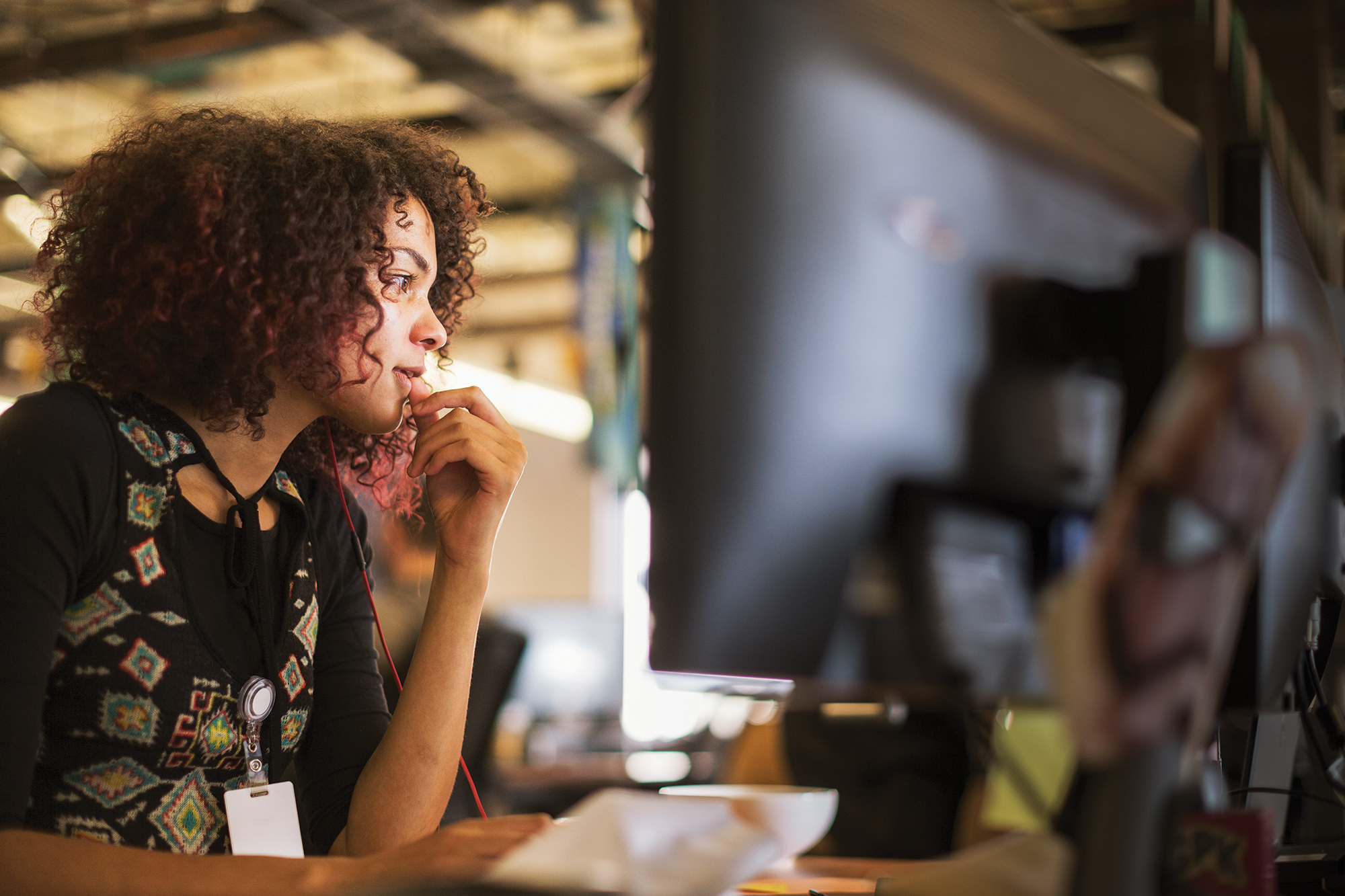 Person looking at screen with wired headset