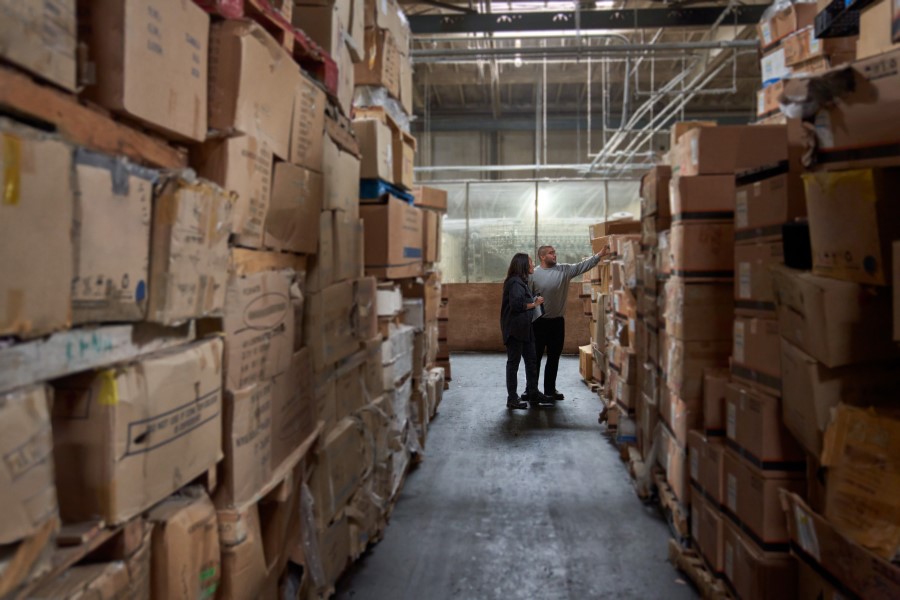 Supply chain employees reviewing inventory.