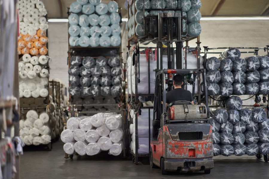 A person driving a forklift in a warehouse