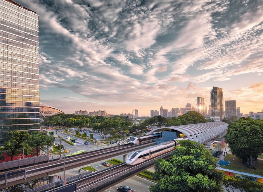a modern monorail system with a city skyline in the background