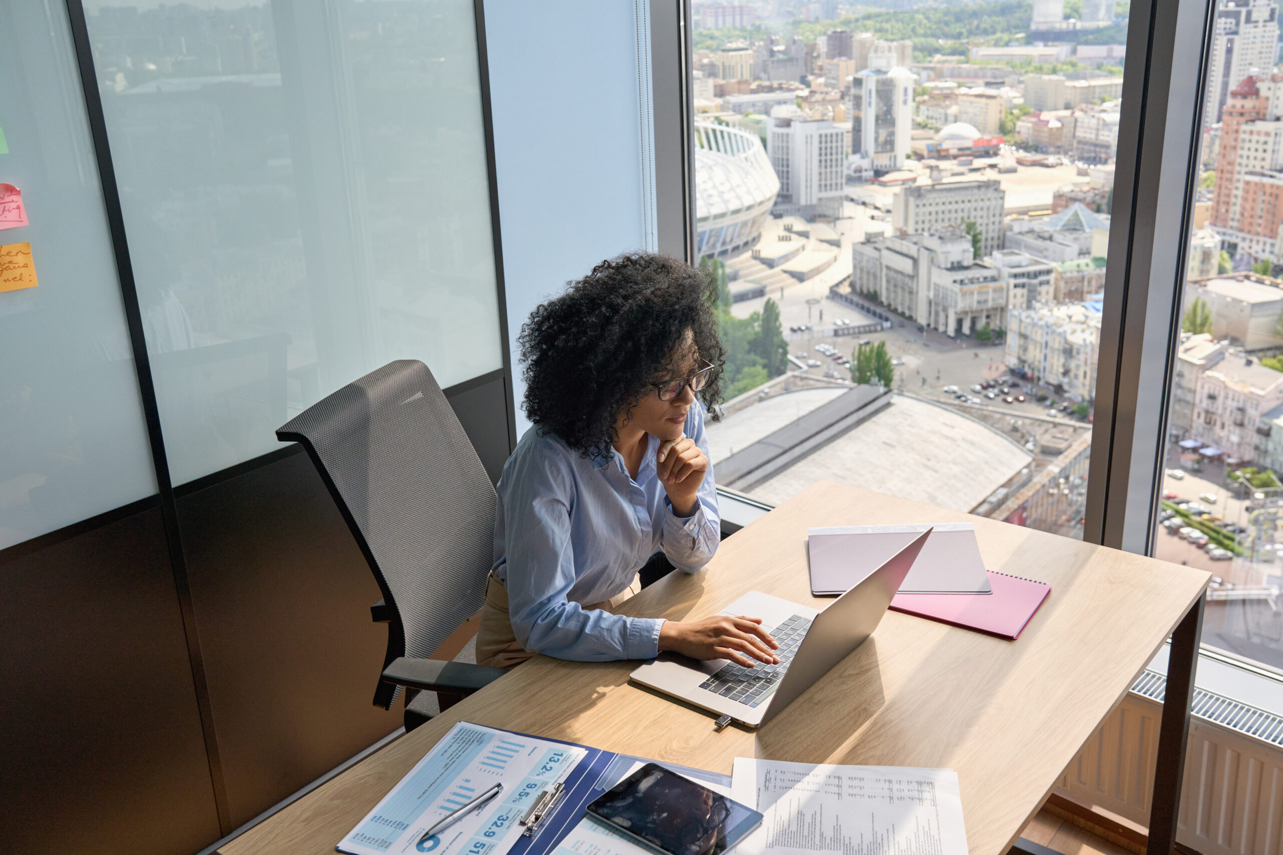 A woman sitting at a desk with a laptop