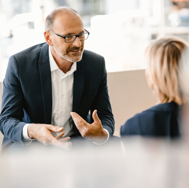 A man in a suit talking to a woman