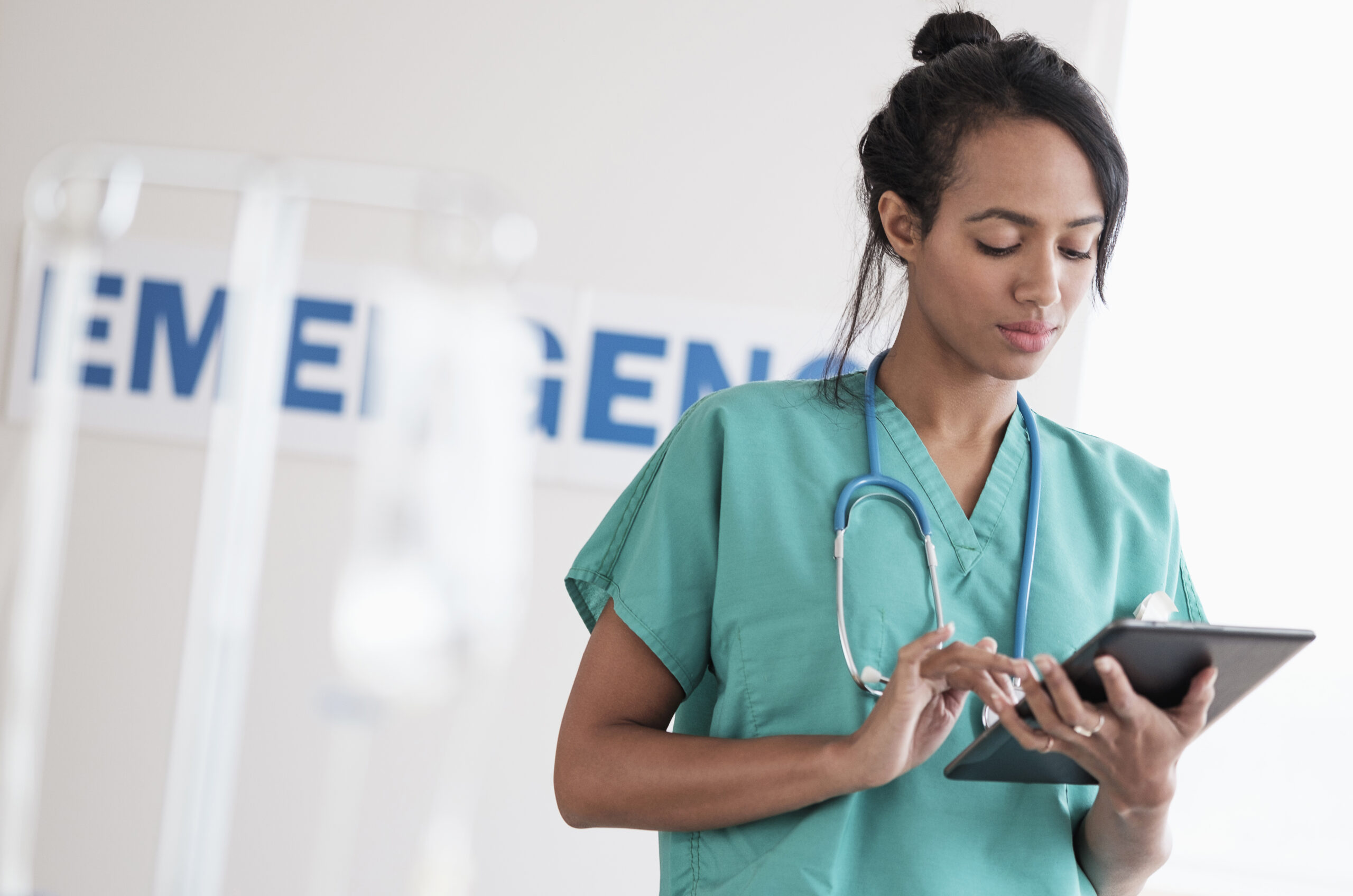 Nurse using a tablet for documentation in an emergency department.