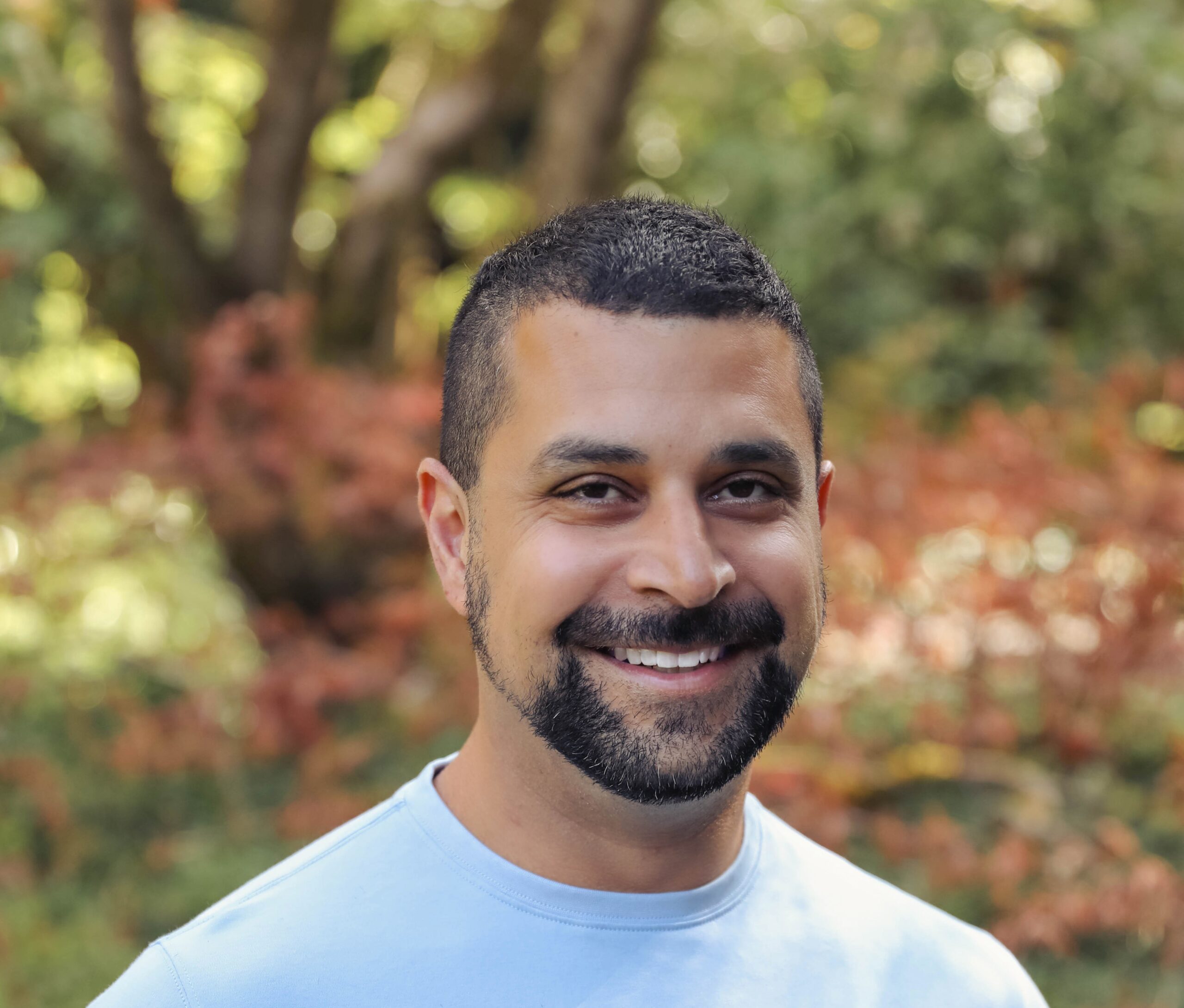 A man with a beard smiling