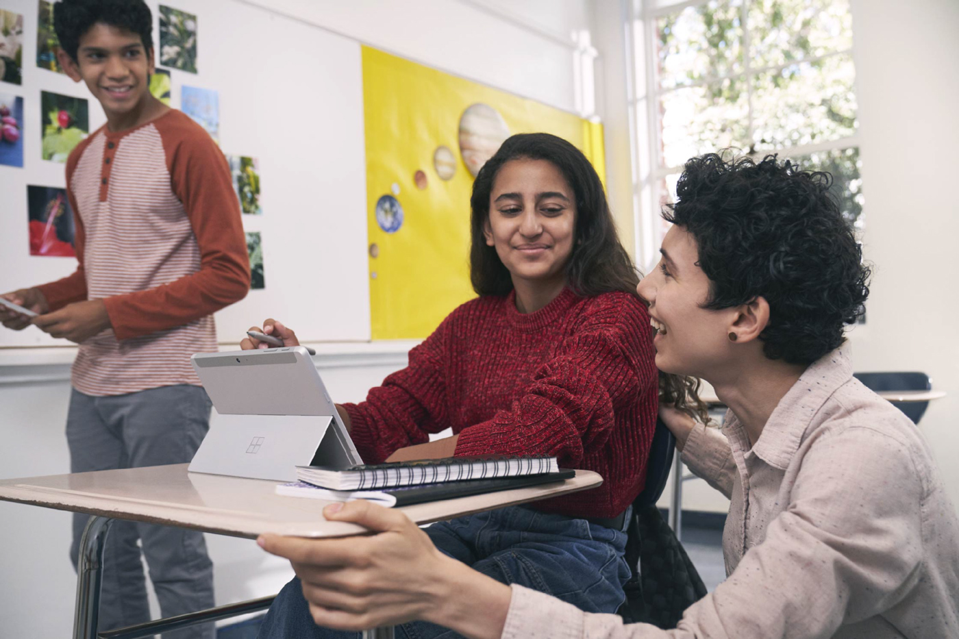 Educator talking with two students.