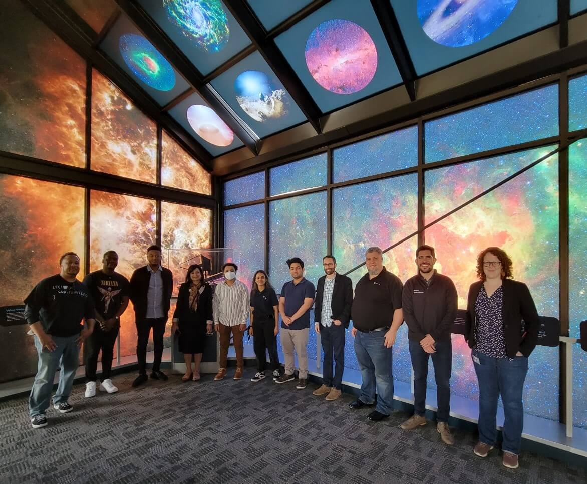 Hackers and mentors from the NASA/Azure Space hackathon meet at NASA's Goddard Space Flight Center. From left: Sr. Azure Specialist Jamal Wade; crew members Demario Asquitt and Mubarek Abdela; The Garage Principle PM Piali Ghose; crew members Getaante Yilma, Anu Uphadhya, and Hridweek Karki; Azure Space Sr. Director Stephen Kitay, Sr. Software Engineer Kevin Mack, Sr. Programming Manager Juan Carlos Lopez; NASA Research Scientist Rebekah Hounsell