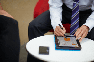 person sitting in chair with a tablet
