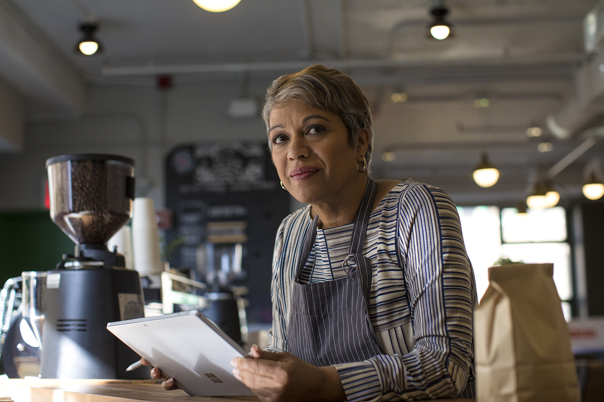 Frontline worker achieving in retail work space using Surface.