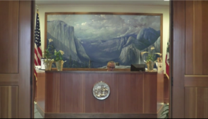 Man sitting at desk in California government office