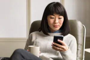 a woman holding a cup of coffee