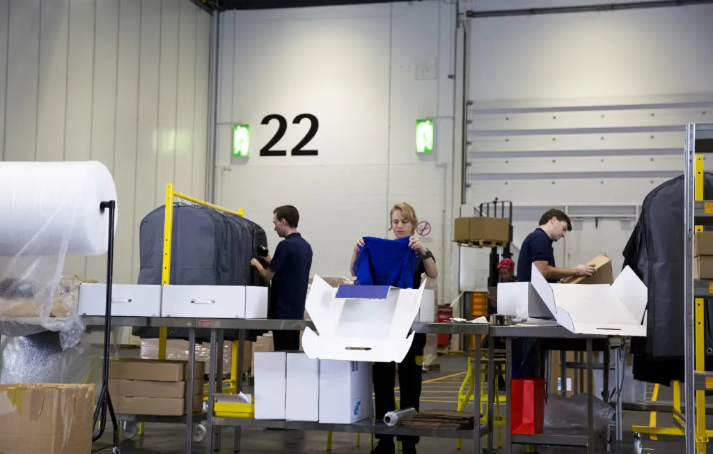 Men and women looking at packages and clothing