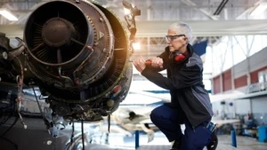 Person working on an airplane in a factory