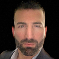 a man wearing a suit and tie looking at the camera