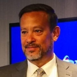 Monte Hong wearing a suit and tie