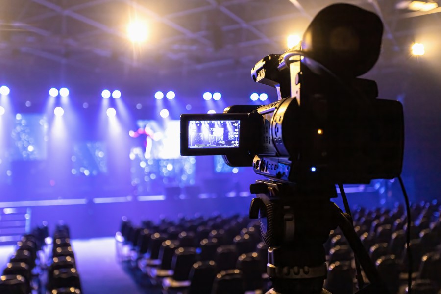 Image of video equipment filming a live stage.