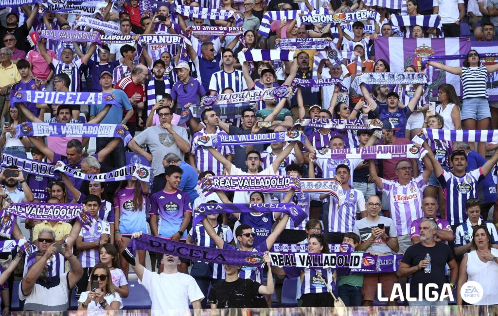 A group of sports fans holding banners
