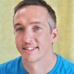 Jon Butler, a smiling man in a blue shirt