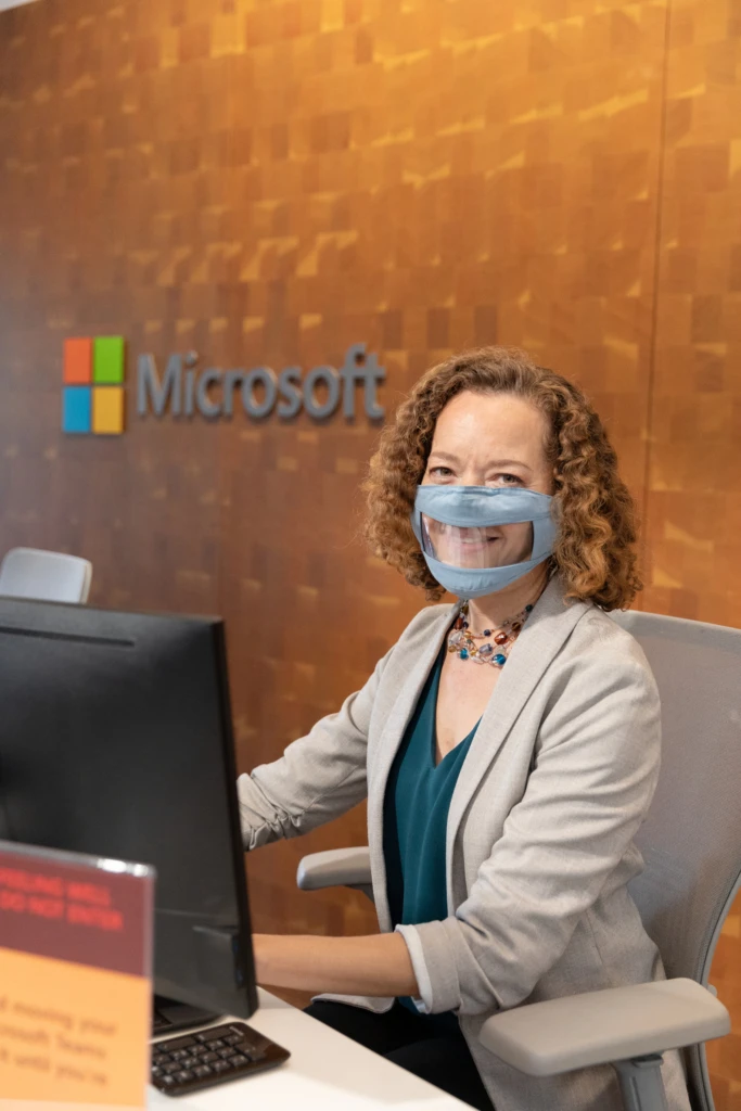 A frontline worker wears a clear facemask for lipreaders to ensure inclusive action