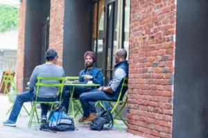 A team of developers have a meeting outside.
