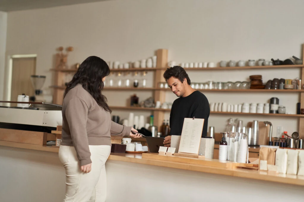 Customer using phone to pay at a cafe.