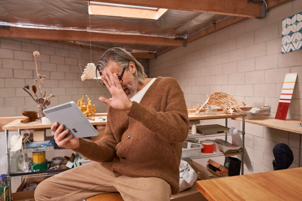 A man participating in a Microsoft Teams healthcare appointment on his Surface tablet