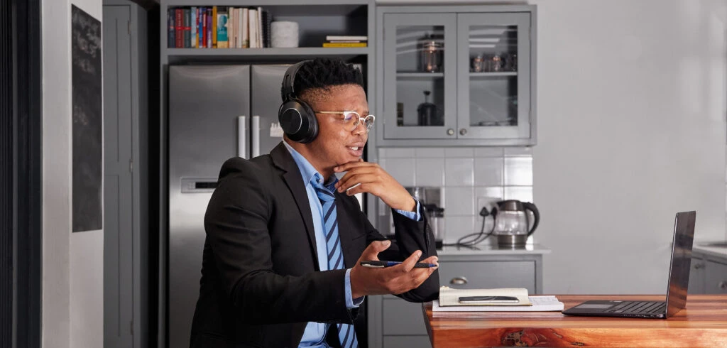 Man sitting in a home kitchen on a Microsoft Teams call