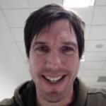 Simon Williams, a man with brown hair smiling at the camera.